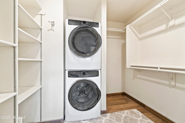 2302 N Norton Ave, Tucson, AZ 85719 - laundry room featuring stacked washer and clothes dryer, wood finished floors, and baseboards