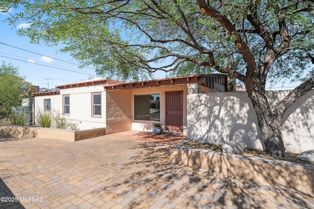 2302 N Norton Ave, Tucson, AZ 85719 - view of front facade featuring brick siding and a patio