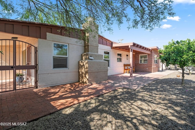2302 N Norton Ave, Tucson, AZ 85719 - back of property featuring a gate, a patio area, and concrete block siding