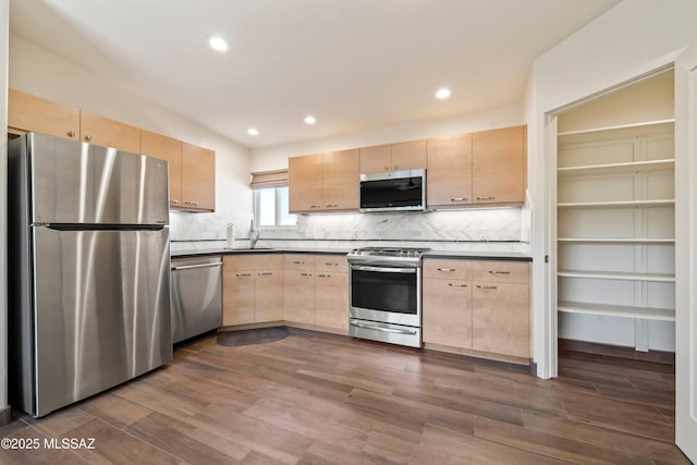 2302 N Norton Ave, Tucson, AZ 85719 - kitchen featuring stainless steel appliances, light brown cabinets, a sink, dark wood-style floors, and tasteful backsplash