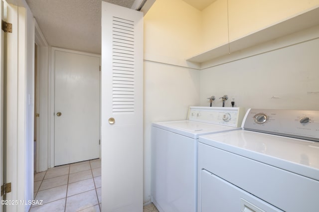 201 N Cloverland Ave, Tucson, AZ 85711 - washroom with washer and clothes dryer and light tile patterned floors