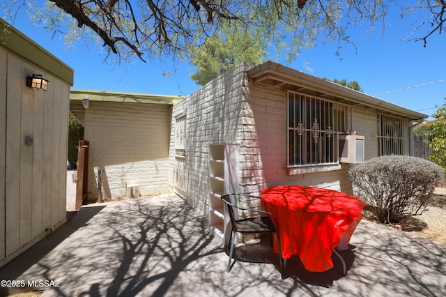 201 N Cloverland Ave, Tucson, AZ 85711 - view of side of property with concrete block siding and a patio area