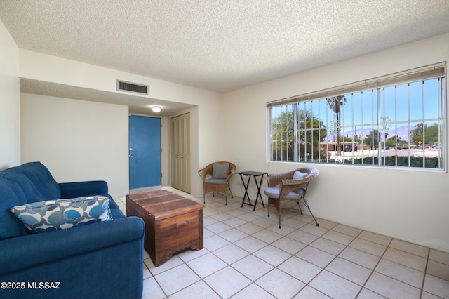 201 N Cloverland Ave, Tucson, AZ 85711 - living area featuring a textured ceiling and light tile patterned floors