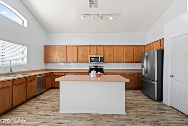 139 W Cheevers St, Vail, AZ 85641 - kitchen featuring stainless steel appliances, a sink, high vaulted ceiling, backsplash, and light countertops