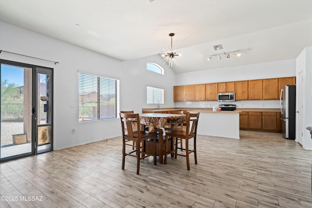 139 W Cheevers St, Vail, AZ 85641 - dining area featuring light wood-style flooring, lofted ceiling, and a chandelier