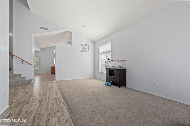139 W Cheevers St, Vail, AZ 85641 - unfurnished living room with high vaulted ceiling, stairway, light wood finished floors, and baseboards