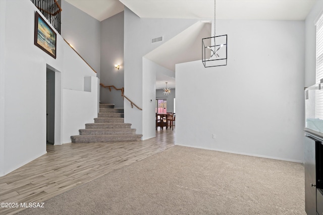 139 W Cheevers St, Vail, AZ 85641 - carpeted entryway with a chandelier, a towering ceiling, stairway, baseboards, and wood finished floors