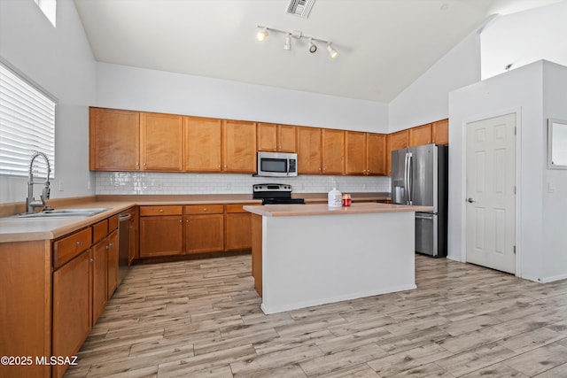 139 W Cheevers St, Vail, AZ 85641 - kitchen featuring appliances with stainless steel finishes, a sink, light countertops, decorative backsplash, and high vaulted ceiling