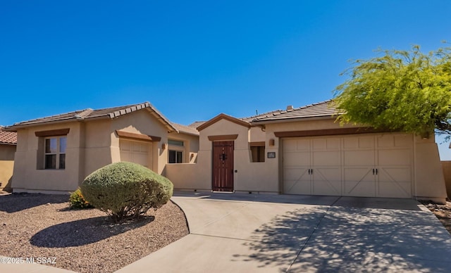 13715 N Tessali Way, Tucson, AZ 85755 - view of front of home with driveway, a tile roof, stucco siding, and a garage