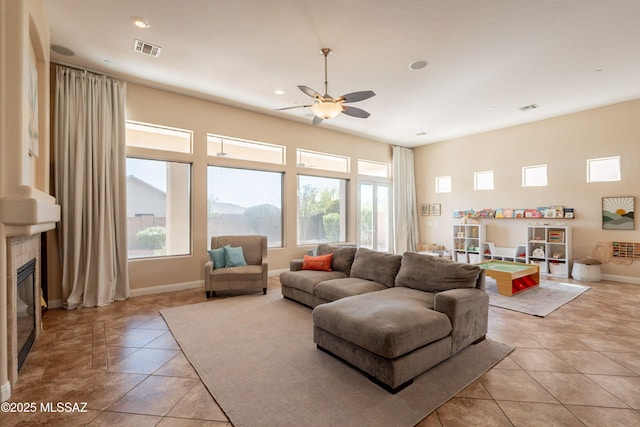 13715 N Tessali Way, Tucson, AZ 85755 - living room with ceiling fan, light tile patterned flooring, a tile fireplace, recessed lighting, and baseboards