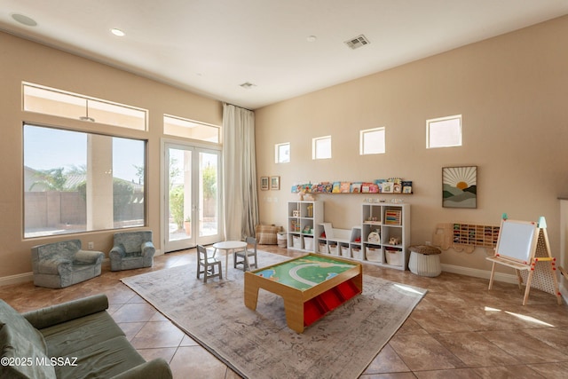 13715 N Tessali Way, Tucson, AZ 85755 - playroom with tile patterned floors, baseboards, and a high ceiling