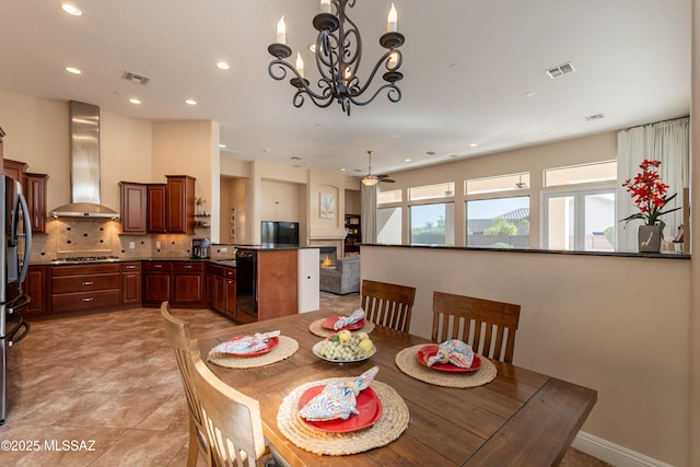 13715 N Tessali Way, Tucson, AZ 85755 - dining room featuring a chandelier, recessed lighting, ceiling fan, and a lit fireplace