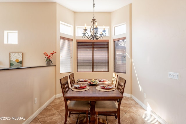 13715 N Tessali Way, Tucson, AZ 85755 - dining room featuring a chandelier, healthy amount of natural light, light tile patterned floors, and a high ceiling