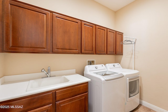 13715 N Tessali Way, Tucson, AZ 85755 - laundry area with washer and clothes dryer, cabinet space, baseboards, and light tile patterned floors