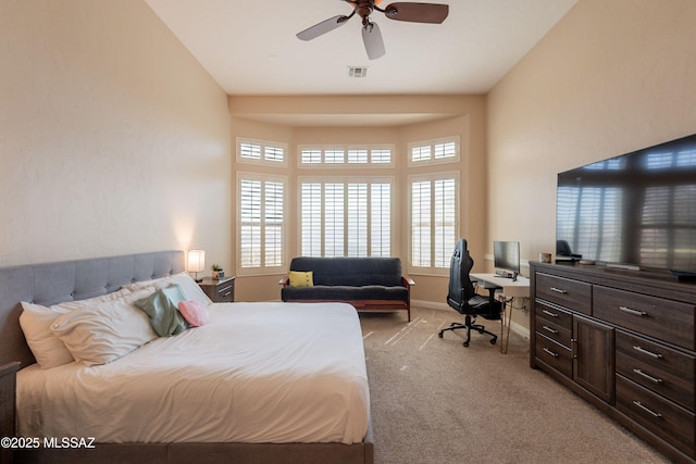 13715 N Tessali Way, Tucson, AZ 85755 - bedroom with light colored carpet, a desk, and a ceiling fan