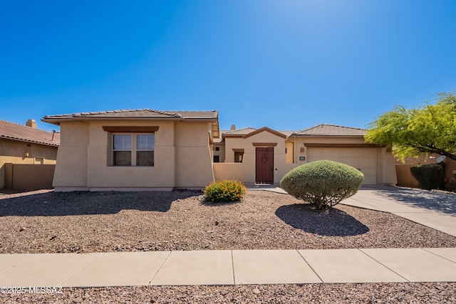 13715 N Tessali Way, Tucson, AZ 85755 - view of front facade featuring a tiled roof, a garage, driveway, and stucco siding
