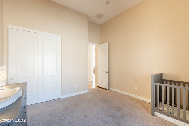 13715 N Tessali Way, Tucson, AZ 85755 - unfurnished bedroom with carpet floors, a sink, a closet, baseboards, and lofted ceiling