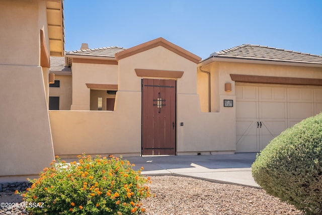 13715 N Tessali Way, Tucson, AZ 85755 - view of front of property featuring a tiled roof, an attached garage, and stucco siding