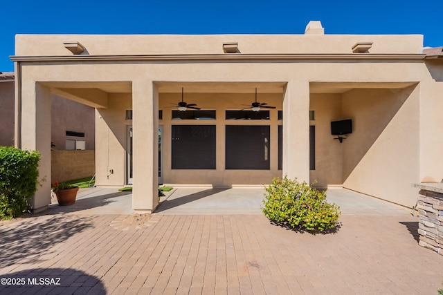 13715 N Tessali Way, Tucson, AZ 85755 - back of property with stucco siding, a ceiling fan, and a patio