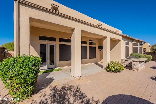 13715 N Tessali Way, Tucson, AZ 85755 - rear view of house with an outdoor kitchen, stucco siding, a ceiling fan, and a patio area