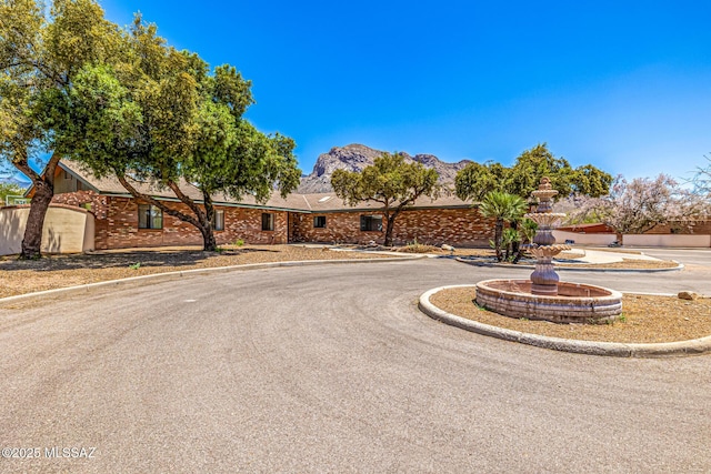 9840 N Desert Sky Rd, Tucson, AZ 85737 - ranch-style home featuring brick siding and a mountain view