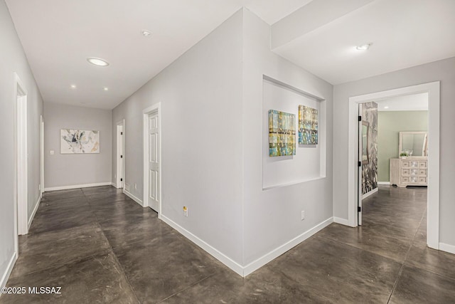 9840 N Desert Sky Rd, Tucson, AZ 85737 - hall featuring concrete floors, baseboards, and recessed lighting