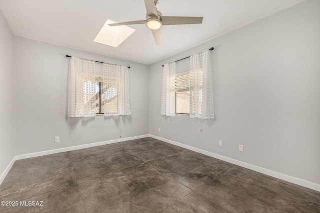 9840 N Desert Sky Rd, Tucson, AZ 85737 - empty room with concrete floors, a skylight, a ceiling fan, and baseboards