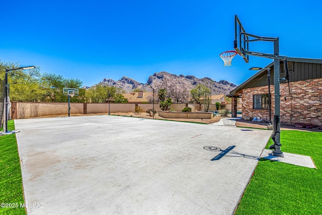9840 N Desert Sky Rd, Tucson, AZ 85737 - view of sport court with basketball hoop and a mountain view
