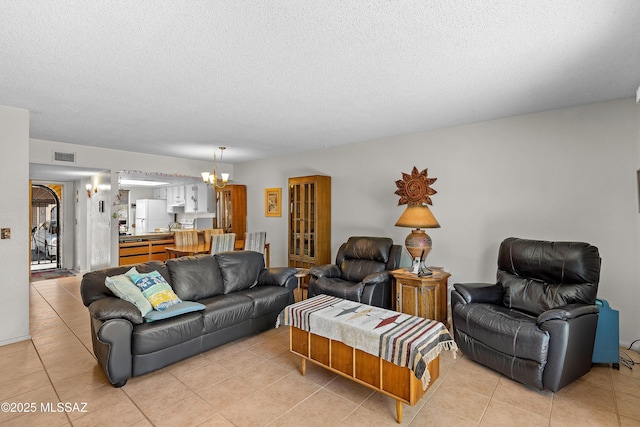 2819 W Jennie Ln, Tucson, AZ 85713 - living room featuring a chandelier, light tile patterned floors, and a textured ceiling
