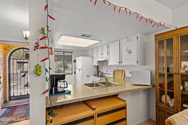 2819 W Jennie Ln, Tucson, AZ 85713 - kitchen with a textured ceiling, white appliances, under cabinet range hood, white cabinetry, and light countertops