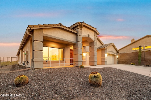 1048 E Rodda River Pl, Tucson, AZ 85718 - view of front facade featuring stucco siding, a garage, driveway, and a tile roof