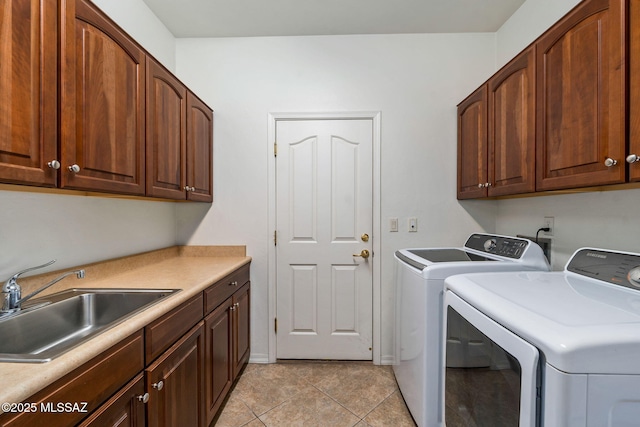 1048 E Rodda River Pl, Tucson, AZ 85718 - laundry room with washer and clothes dryer, cabinet space, and light tile patterned flooring