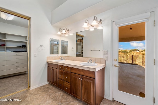 1048 E Rodda River Pl, Tucson, AZ 85718 - full bath featuring double vanity, a spacious closet, and tile patterned flooring