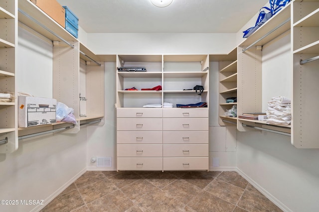 1048 E Rodda River Pl, Tucson, AZ 85718 - walk in closet with dark tile patterned flooring