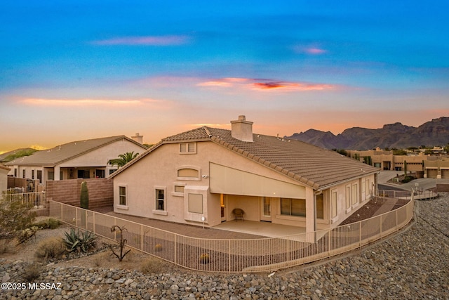 1048 E Rodda River Pl, Tucson, AZ 85718 - back of property with a chimney, a tile roof, a fenced backyard, a patio, and stucco siding