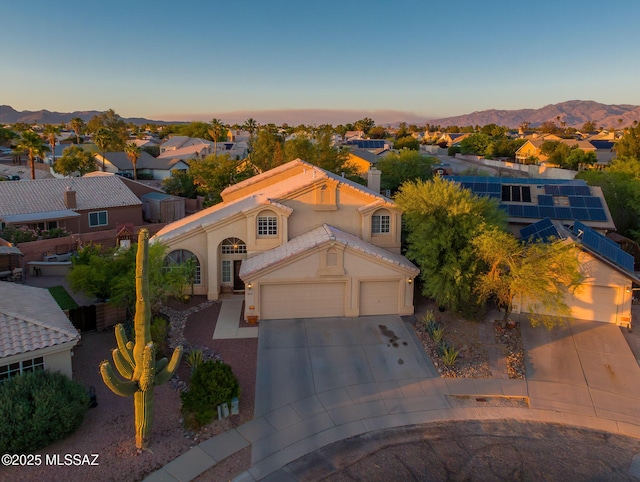 8944 N Hartman Ln, Tucson, AZ 85742 - aerial view at dusk of a mountain view and a residential view