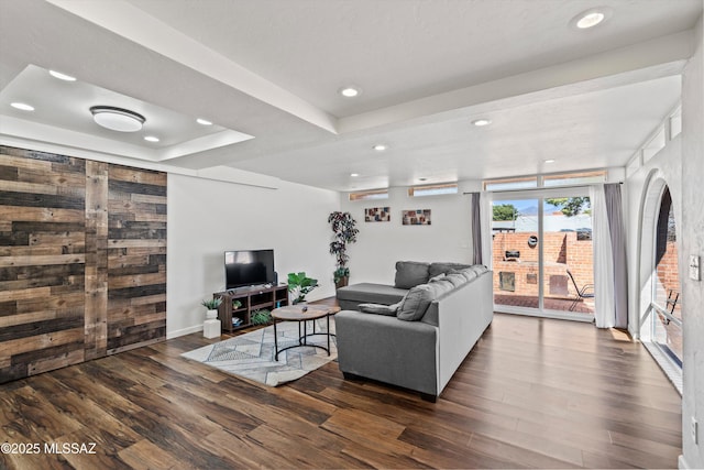 5247 E 6th St, Tucson, AZ 85711 - living room featuring wood finished floors, recessed lighting, a raised ceiling, baseboards, and arched walkways