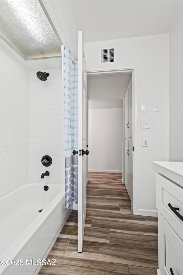 5247 E 6th St, Tucson, AZ 85711 - bathroom with wood finished floors, shower / tub combo with curtain, vanity, and baseboards