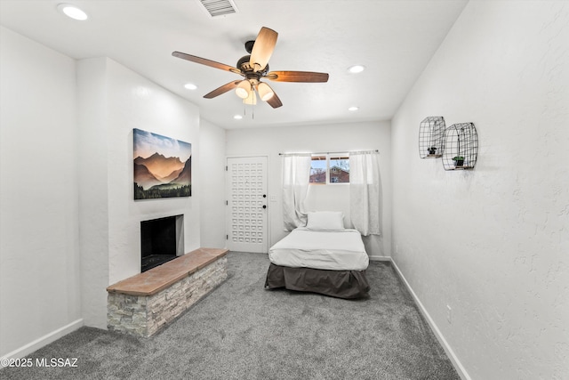 5247 E 6th St, Tucson, AZ 85711 - carpeted bedroom with baseboards, recessed lighting, a fireplace with raised hearth, and ceiling fan