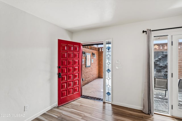 5247 E 6th St, Tucson, AZ 85711 - entryway featuring plenty of natural light, baseboards, and wood finished floors
