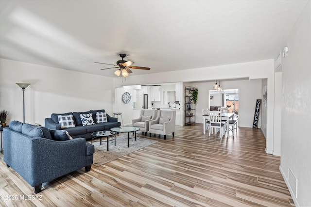 5247 E 6th St, Tucson, AZ 85711 - living area featuring light wood-style flooring and a ceiling fan