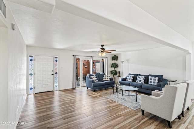 5247 E 6th St, Tucson, AZ 85711 - living room featuring wood finished floors, ceiling fan, and baseboards