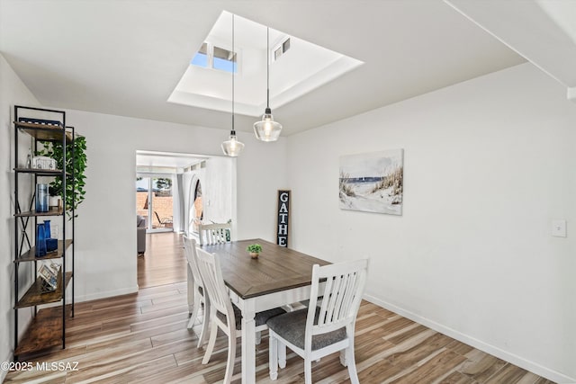 5247 E 6th St, Tucson, AZ 85711 - dining space featuring light wood-type flooring, baseboards, and a tray ceiling