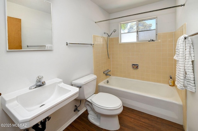 5721 E Scarlett St, Tucson, AZ 85711 - bathroom with toilet, bathing tub / shower combination, a sink, and wood finished floors