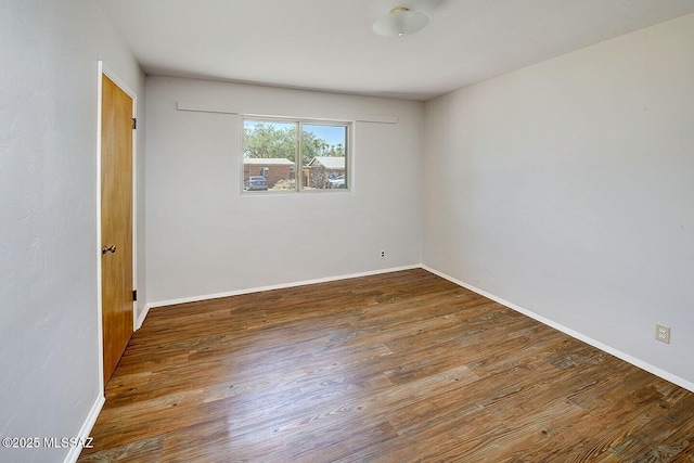 5721 E Scarlett St, Tucson, AZ 85711 - spare room featuring wood finished floors and baseboards