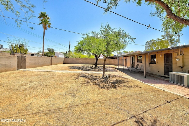 5721 E Scarlett St, Tucson, AZ 85711 - fenced backyard featuring central AC unit and a patio