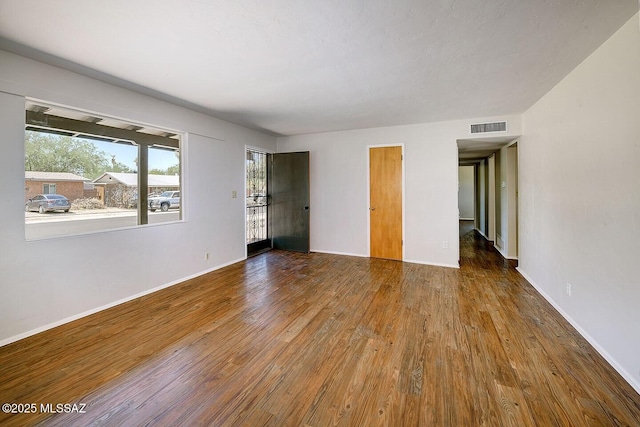 5721 E Scarlett St, Tucson, AZ 85711 - unfurnished room with wood finished floors and baseboards