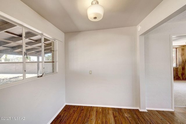 5721 E Scarlett St, Tucson, AZ 85711 - unfurnished room with baseboards, wood finished floors, and a smoke detector