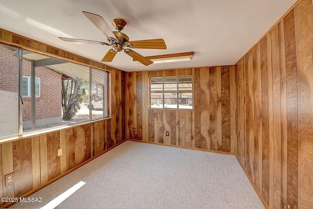 5721 E Scarlett St, Tucson, AZ 85711 - carpeted spare room with wooden walls and ceiling fan