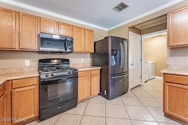 1173 W Calle Vista De Suenos, Sahuarita, AZ 85629 - kitchen with appliances with stainless steel finishes, independent washer and dryer, ornamental molding, light countertops, and light tile patterned flooring